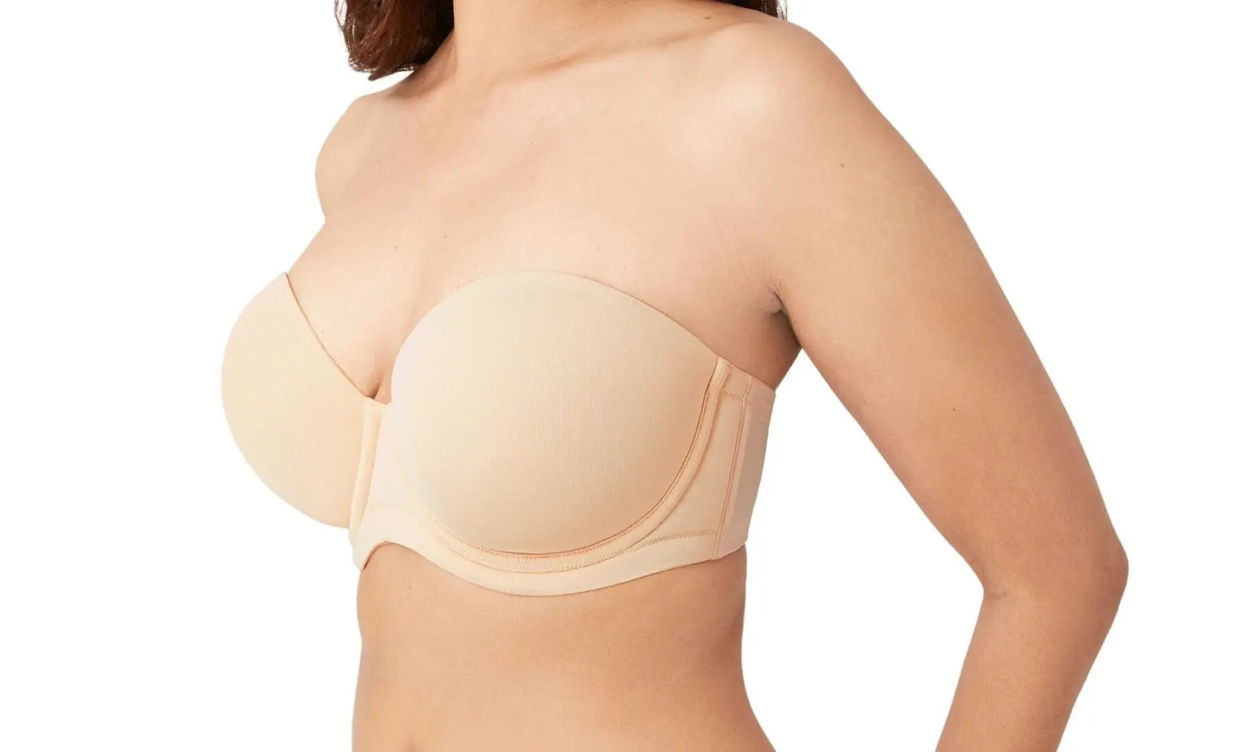 A woman wearing a nude strapless bra.