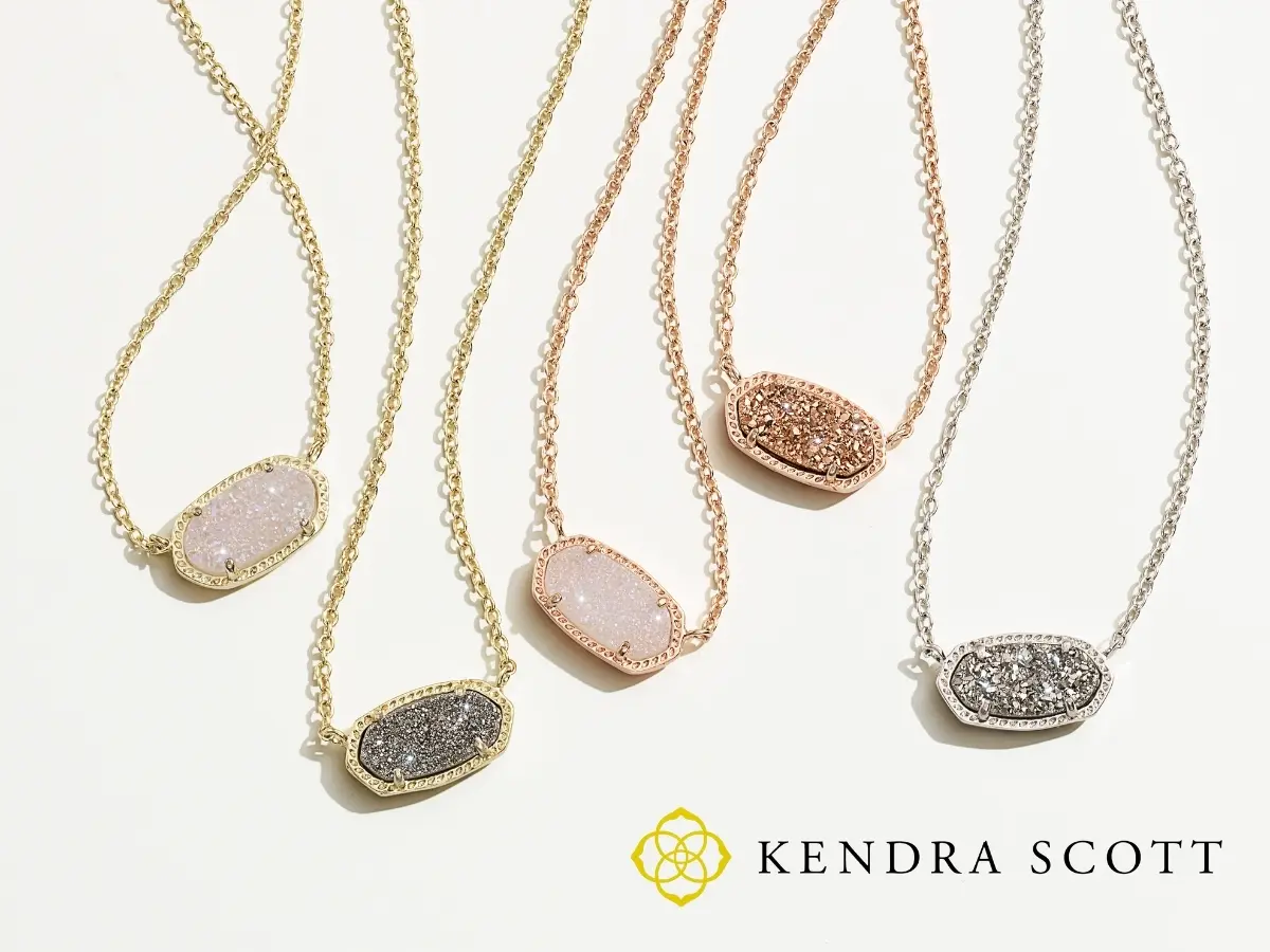 A collection of kendra scott pendant necklaces with various colored druzy stones displayed on a white background.