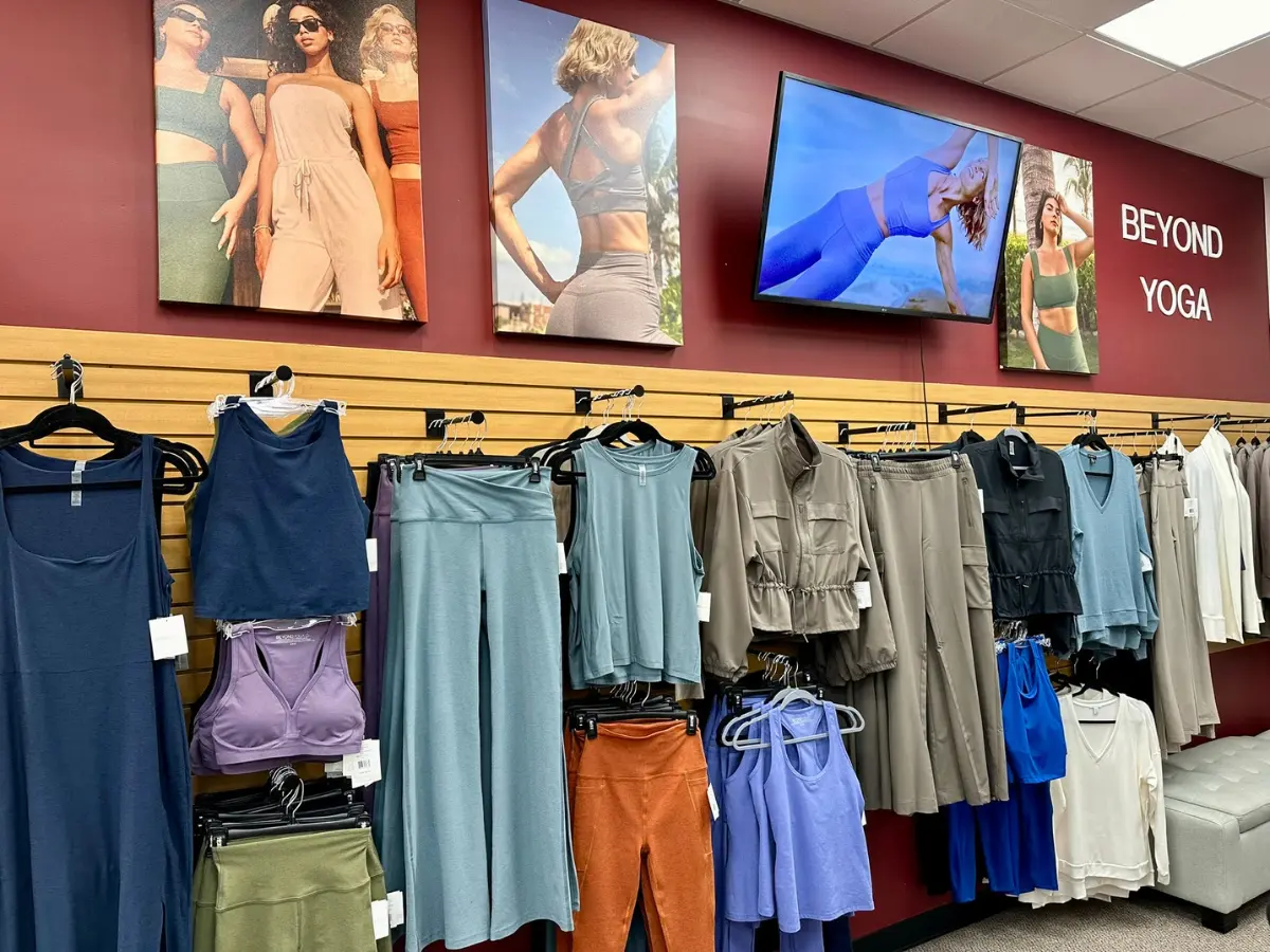 Women's clothing display with "Beyond Yoga" sign.